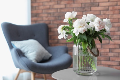 Photo of Vase with beautiful flowers on table indoors. Interior decor element