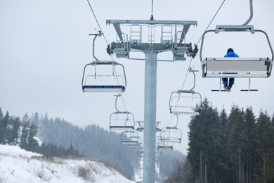 Man on chairlift at ski resort. Winter vacation