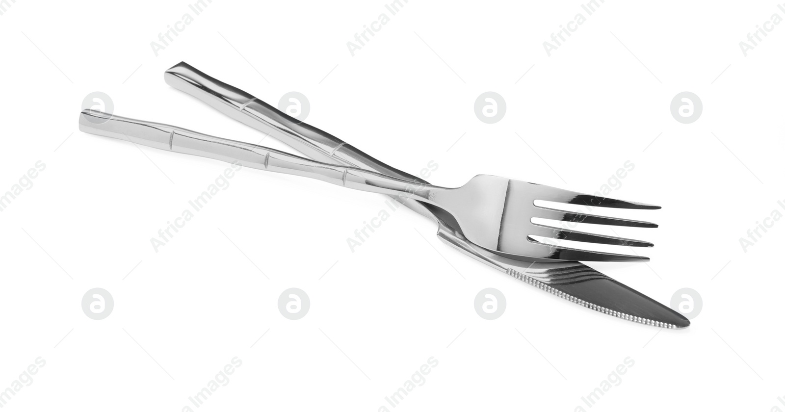 Photo of Fork and knife isolated on white. Stylish shiny cutlery set