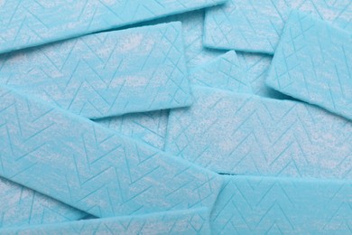 Photo of Sticks of light blue chewing gum as background, top view