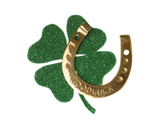Photo of Golden horseshoe with phrase GOOD LUCK and clover on white background. St. Patrick's Day celebration