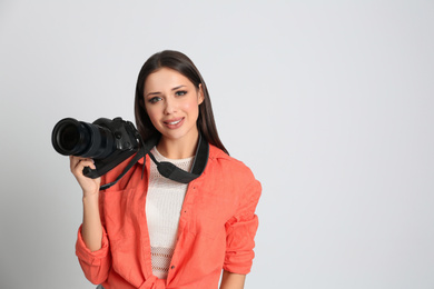 Photo of Professional photographer working on white background in studio