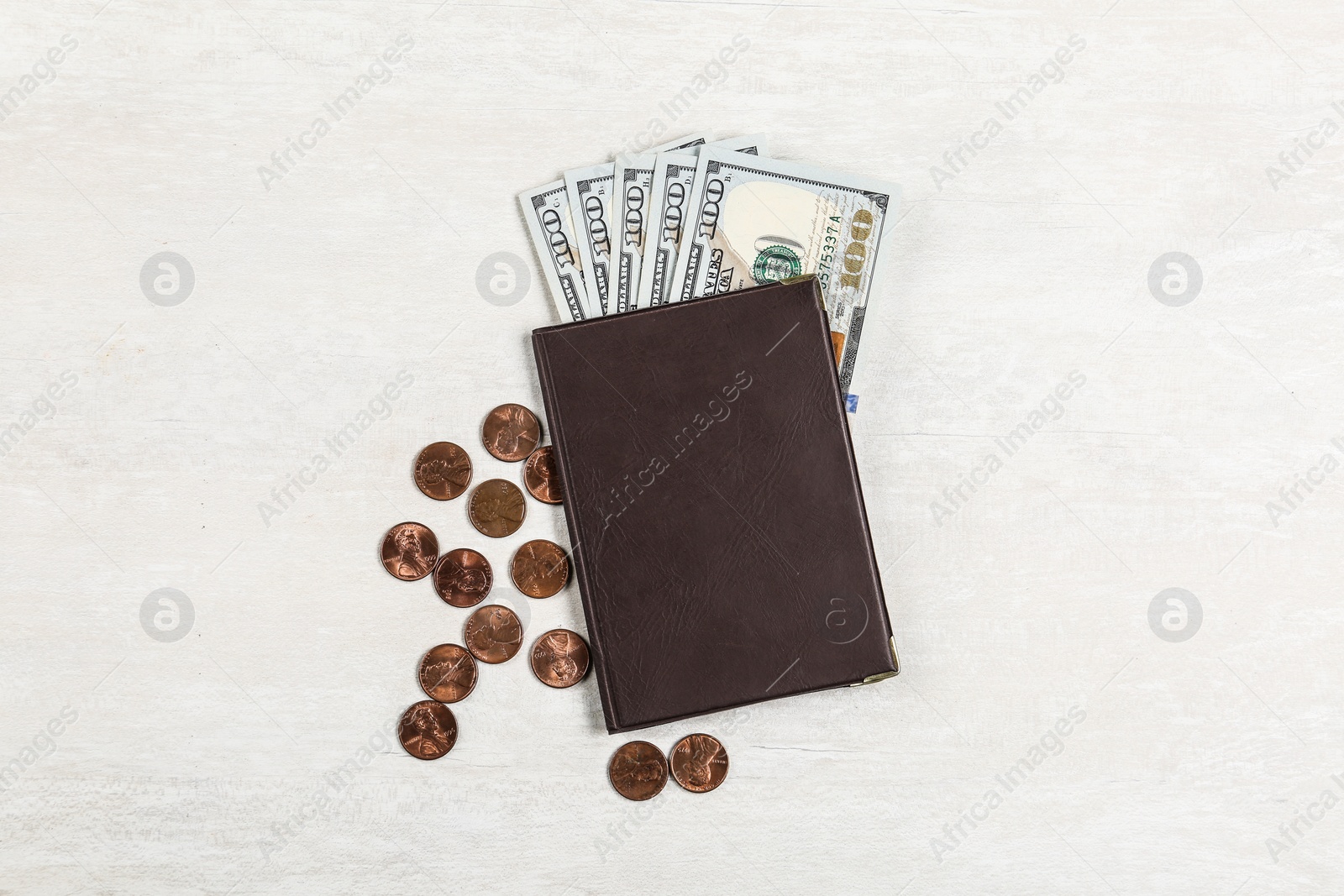 Photo of Pension certificate with American coins and dollars on grey stone table, flat lay