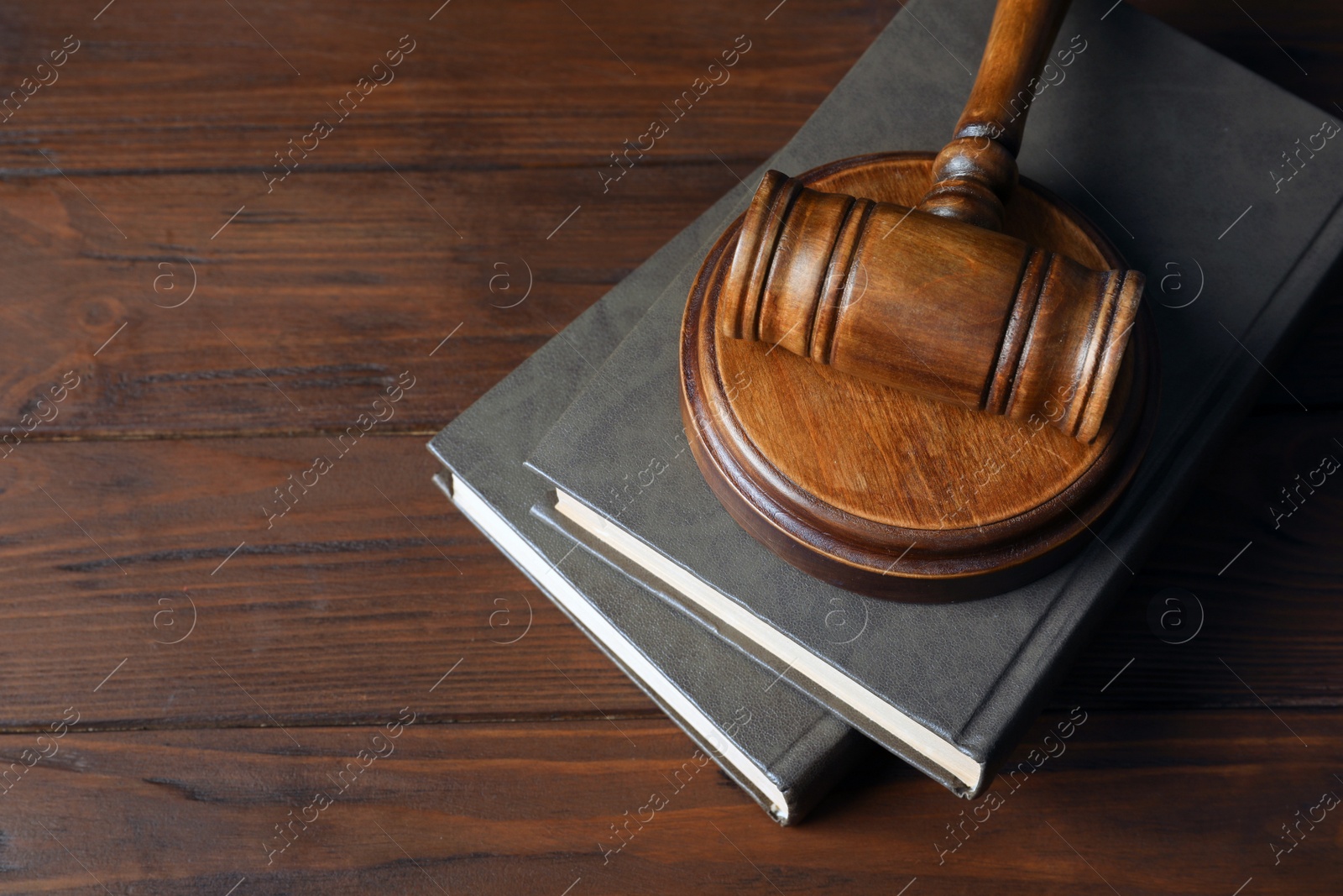 Photo of Judge gavel and books on wooden background. Law concept