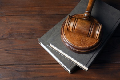 Photo of Judge gavel and books on wooden background. Law concept