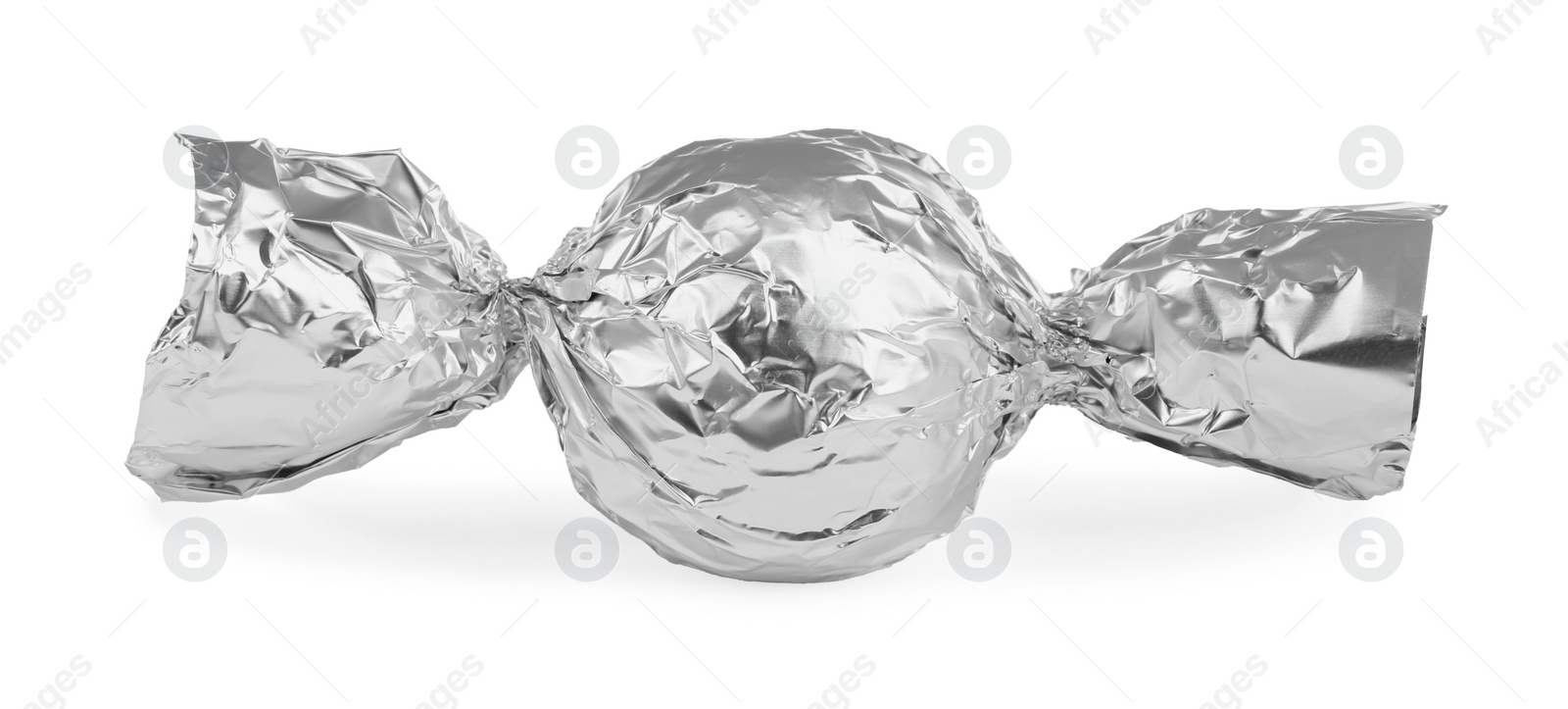 Photo of Tasty candy in silver wrapper isolated on white