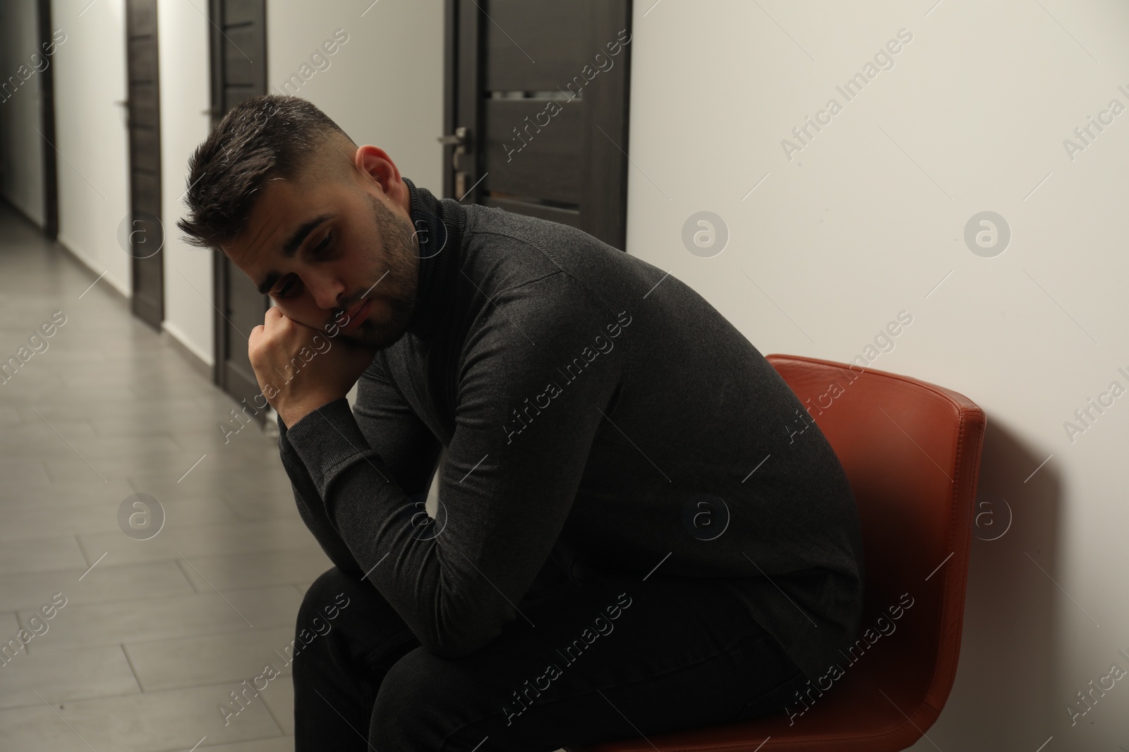 Photo of Portrait of sad young man in hall