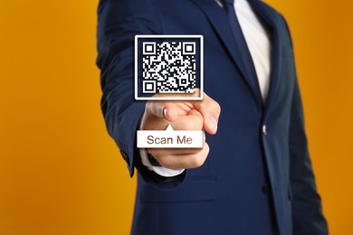 Image of Man pointing at illustration of QR code on orange background, closeup