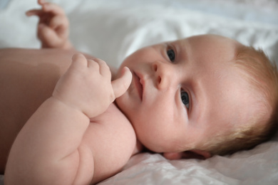 Photo of Cute little newborn baby on bed, closeup