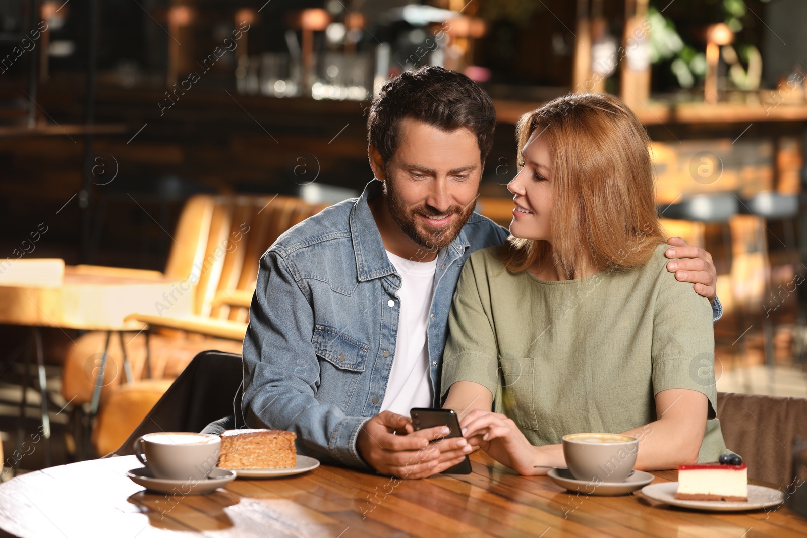 Photo of Romantic date. Lovely couple spending time together in cafe