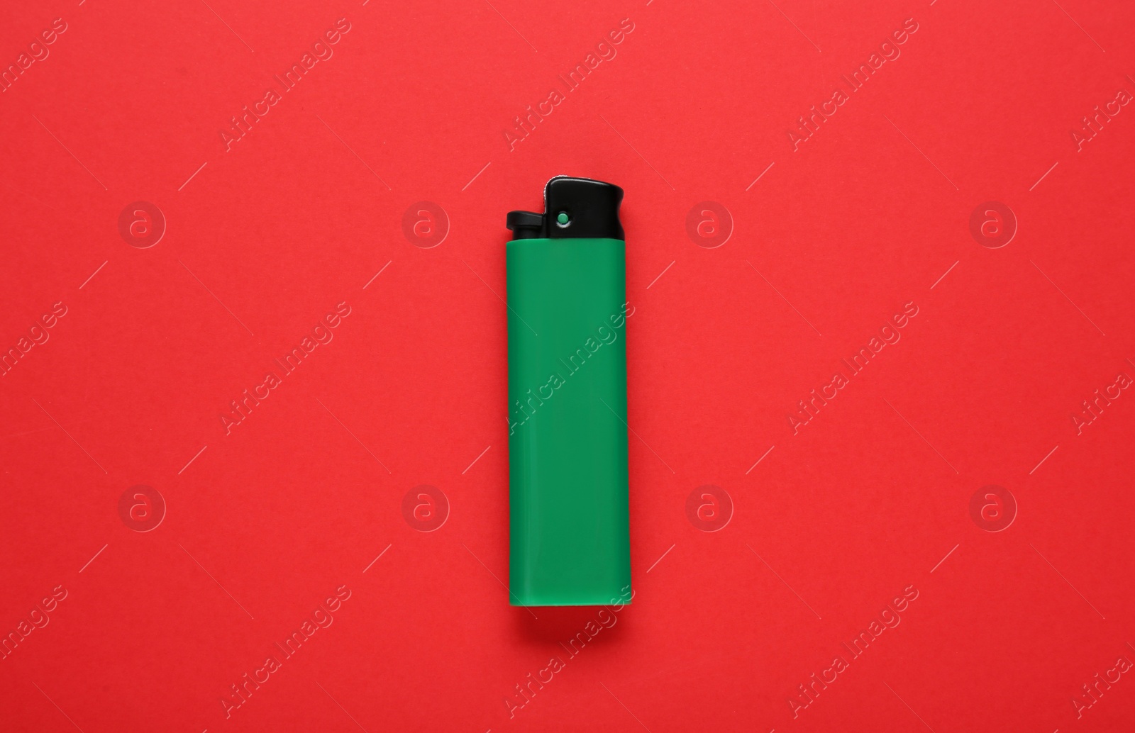 Photo of Stylish small pocket lighter on red background, top view