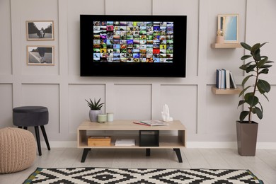 Photo of Stylish living room interior with modern TV on white wall