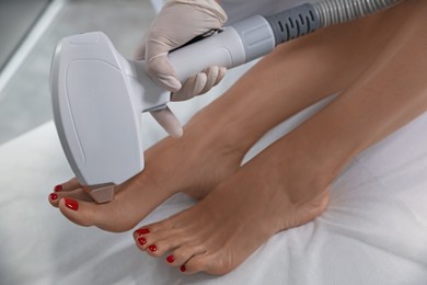 Woman undergoing laser epilation procedure in beauty salon, closeup