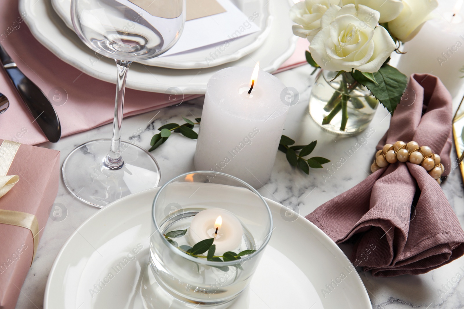 Photo of Elegant festive table setting on white marble background, closeup