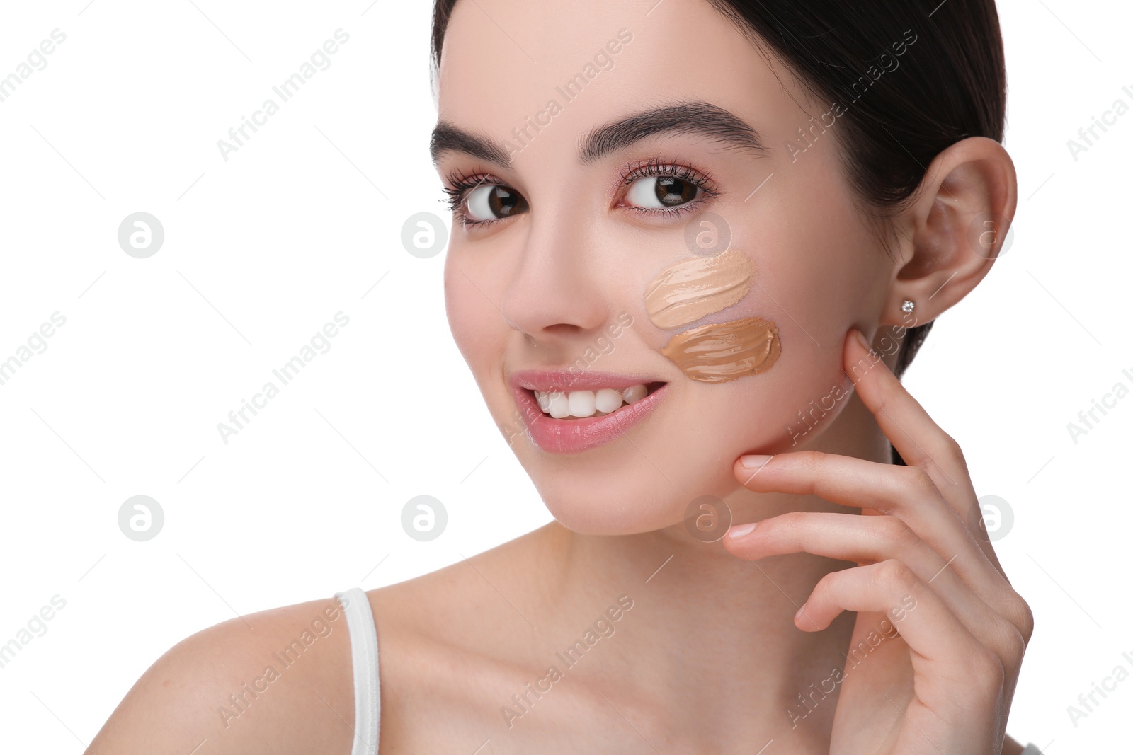 Photo of Teenage girl with swatches of foundation on face against white background