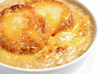 Photo of Tasty homemade french onion soup on white background, closeup