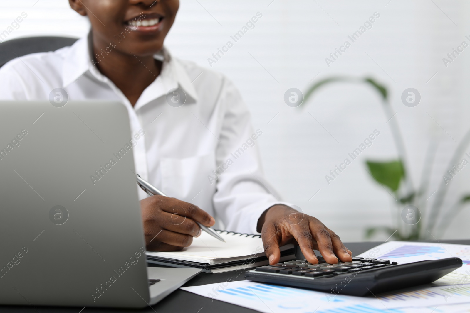 Photo of Professional accountant working at desk in office, closeup