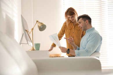 Photo of Professional designers working together in modern office