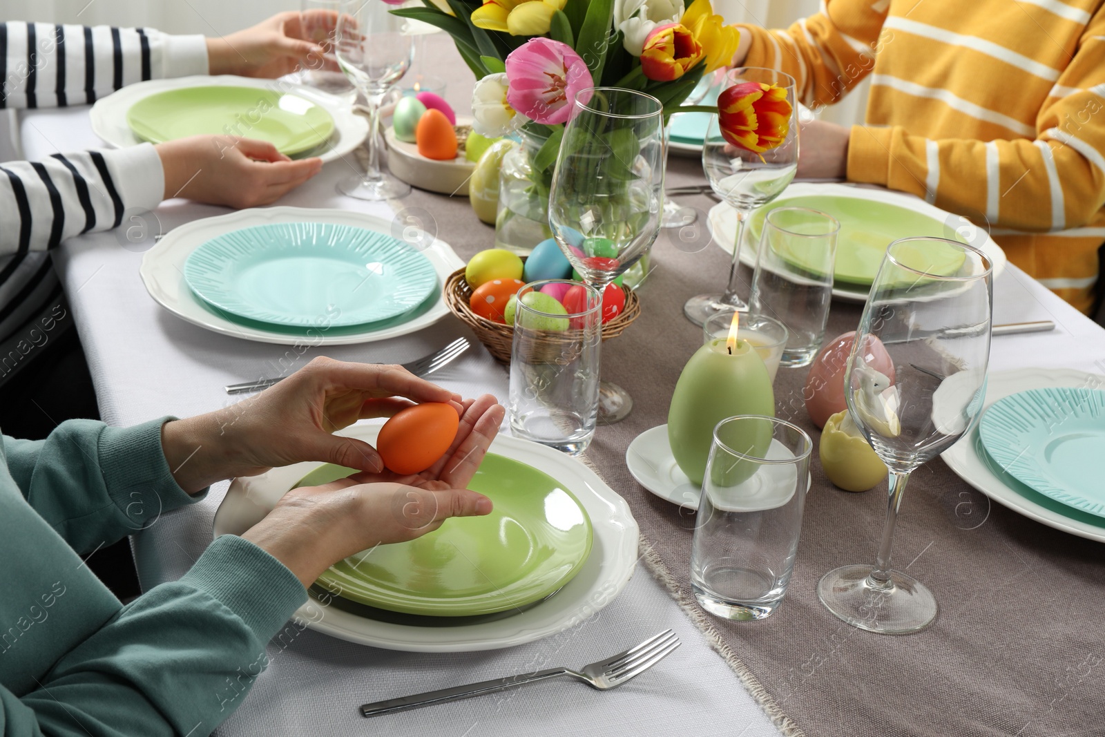 Photo of Festive table setting. Women celebrating Easter at home, closeup