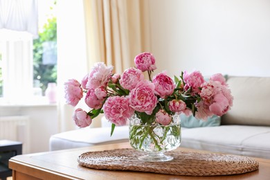 Beautiful pink peonies in vase on table at home. Interior design