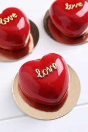 Photo of St. Valentine's Day. Delicious heart shaped cakes on white wooden table, above view