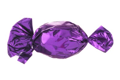 Candy in purple wrapper isolated on white