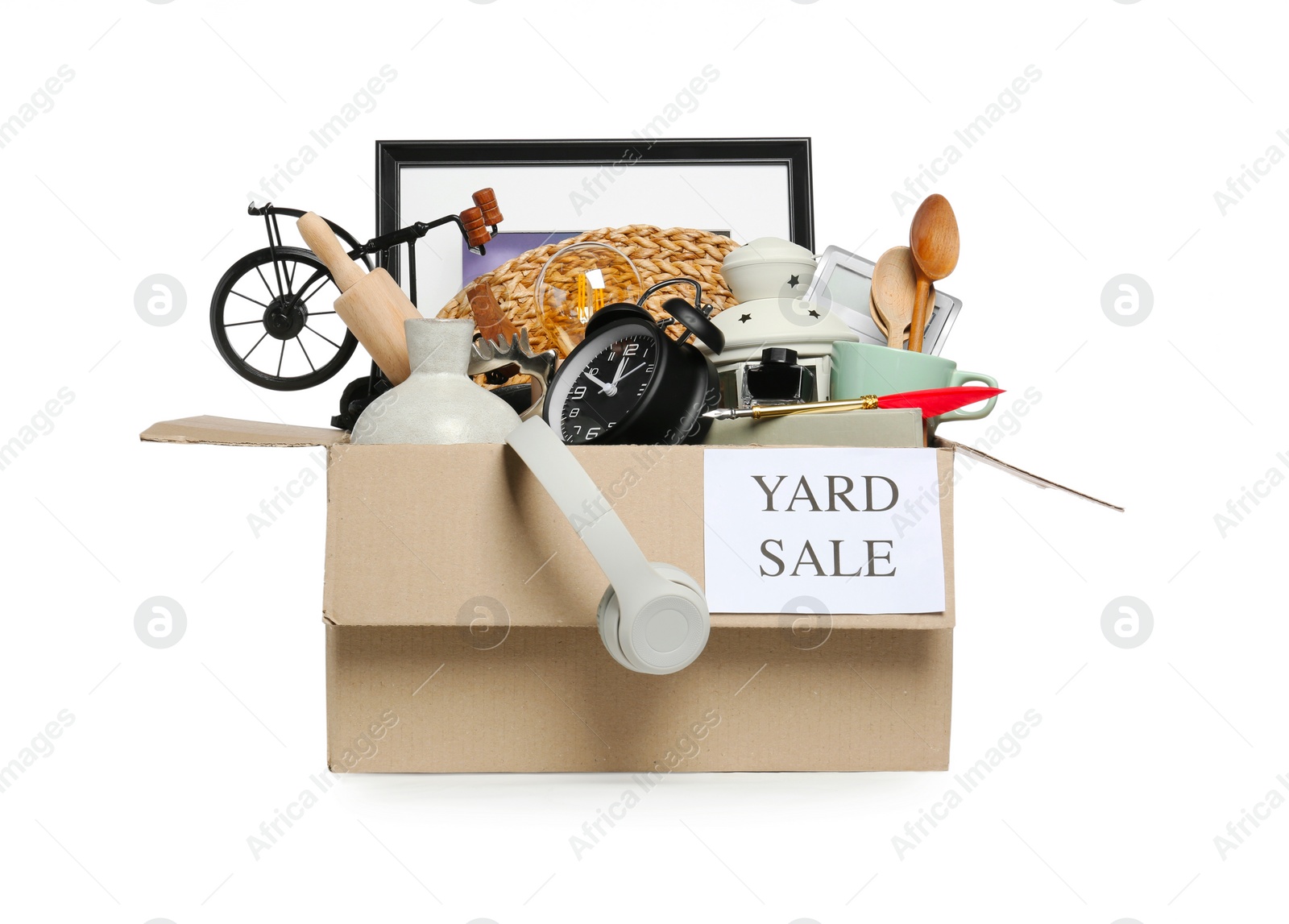 Photo of Sign Yard Sale written on box with different stuff isolated on white