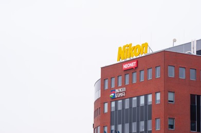Photo of Warsaw, Poland - September 10, 2022: Building with modern Nikon, Neonet and North Coast logos