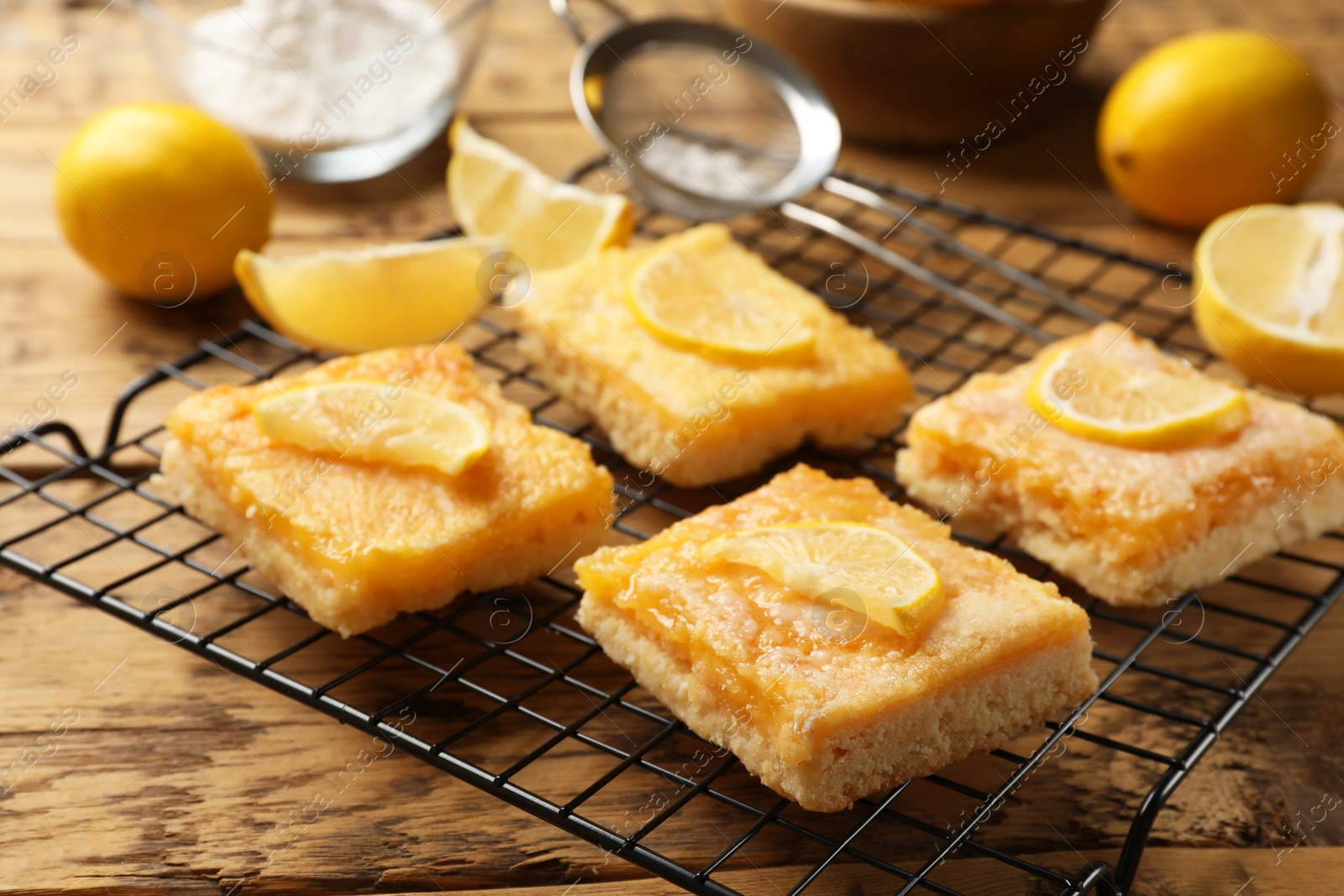 Photo of Tasty lemon bars on wooden table, closeup