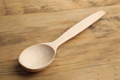 Photo of New handmade wooden spoon on rustic table