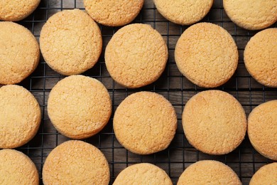 Photo of Many tasty sugar cookies on wooden table, top view