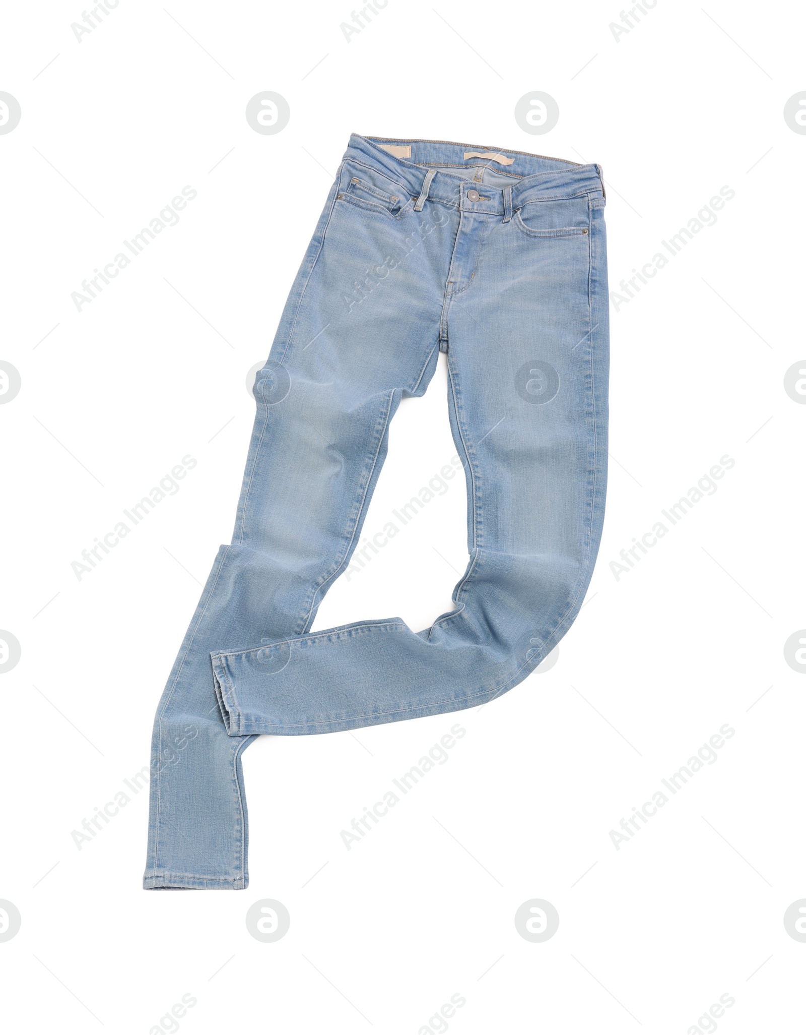 Photo of Stylish light blue jeans isolated on white, top view