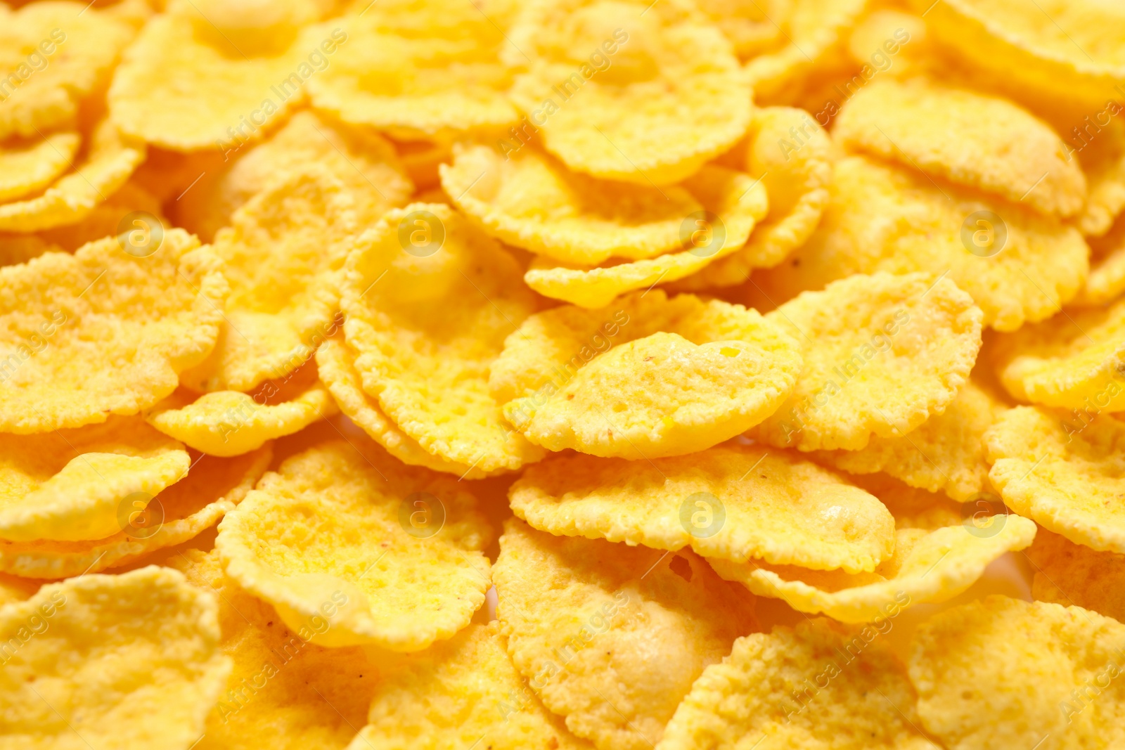 Photo of Tasty crispy corn flakes as background, closeup