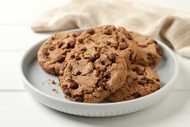 Photo of Delicious chocolate chip cookies on white wooden table, closeup