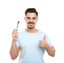 Photo of Young man with toothbrush on white background. Teeth care