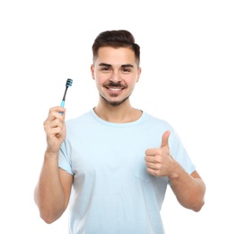 Young man with toothbrush on white background. Teeth care