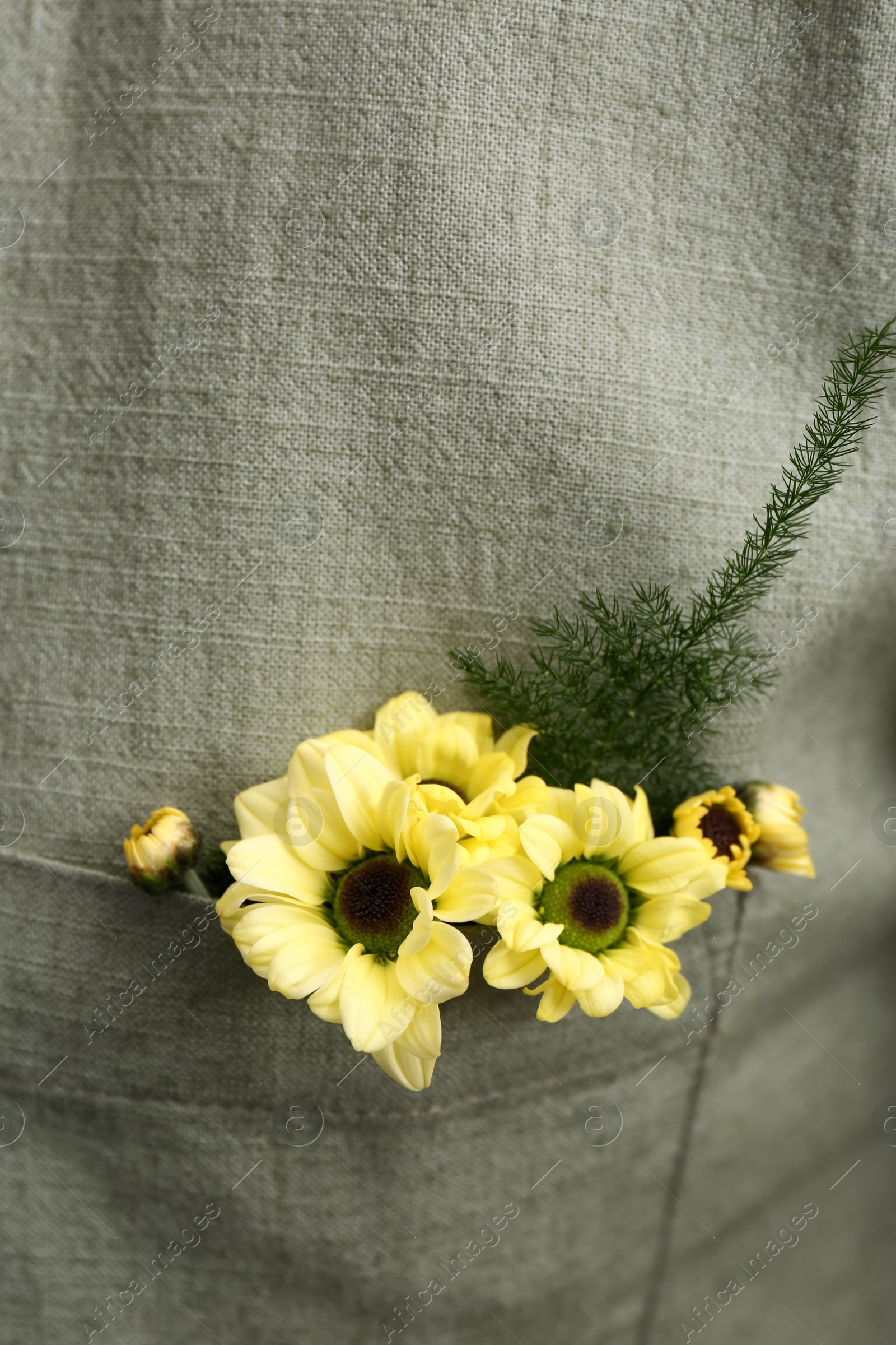 Photo of Woman wearing shirt with flowers in pocket, closeup