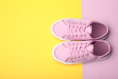 Photo of Stylish new shoes on color background, top view