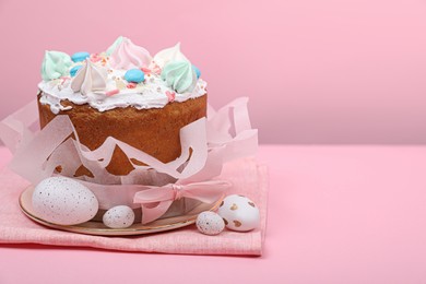 Photo of Traditional Easter cake with meringues and painted eggs on pink background, space for text