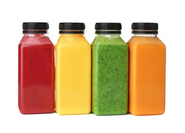 Bottles with delicious detox smoothies on white background