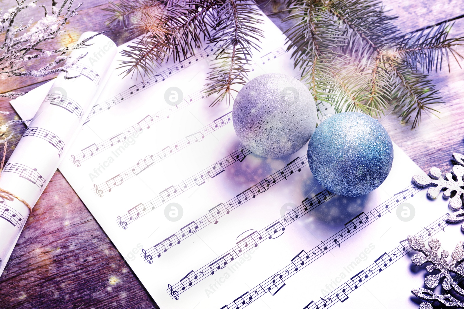 Image of Composition with Christmas decorations and music sheets on wooden background