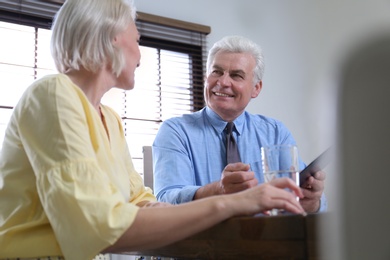 Senior notary working with client in office