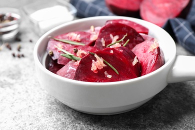 Photo of Raw beetroot slices, garlic and rosemary on grey table, closeup