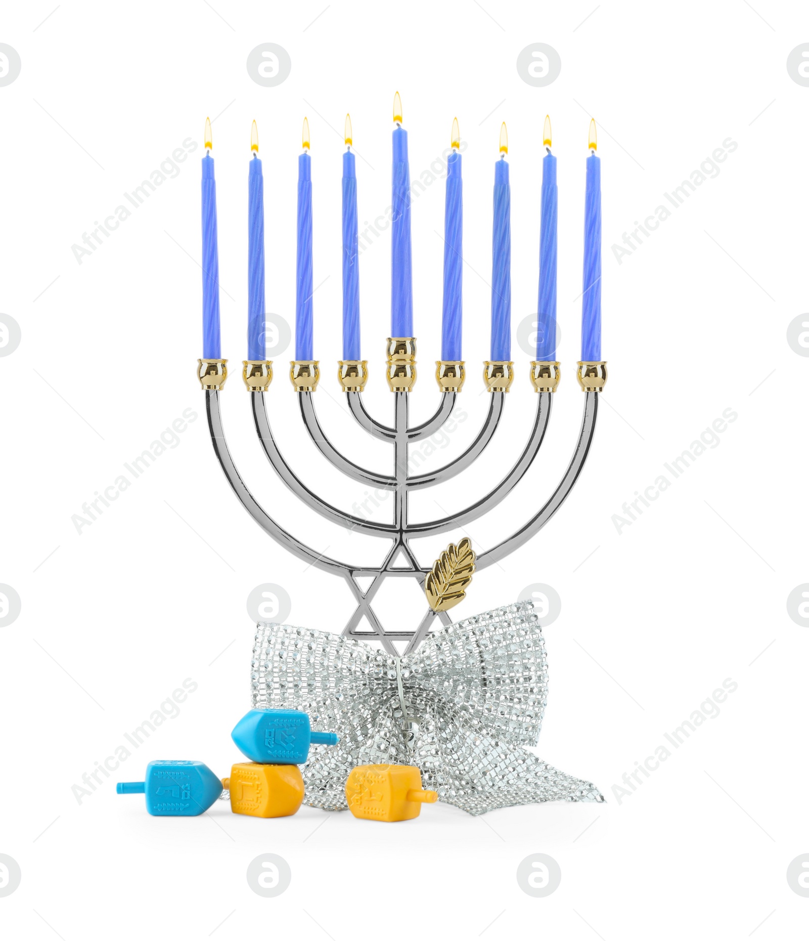 Photo of Hanukkah celebration. Menorah with blue candles, bow and dreidels isolated on white