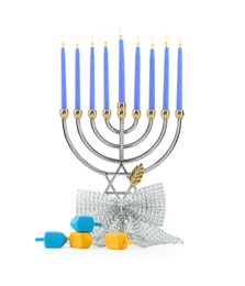 Photo of Hanukkah celebration. Menorah with blue candles, bow and dreidels isolated on white