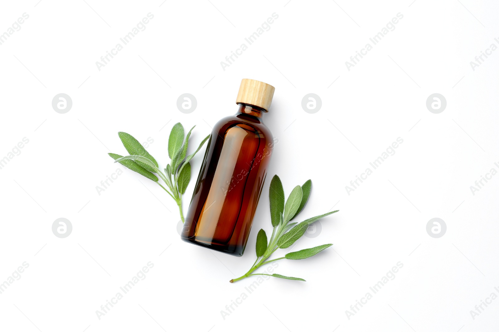 Photo of Bottles of essential sage oil and twigs on white background, top view