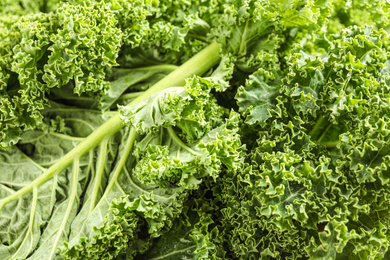 Fresh green kale leaves as background, closeup