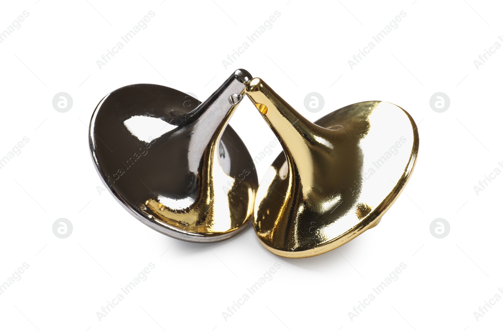 Photo of Golden and silver spinning tops on white background