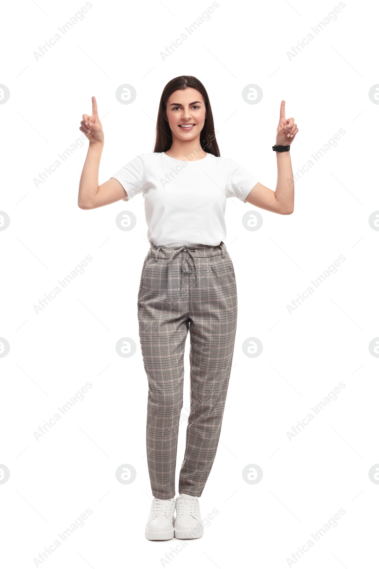 Photo of Beautiful happy businesswoman pointing at something on white background