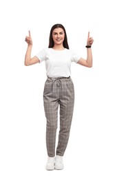 Beautiful happy businesswoman pointing at something on white background